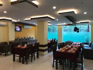 a restaurant with tables and chairs and a bar at Kaveri Inn in Kathmandu