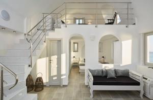 a living room with a staircase and a couch at Aroma Suites in Fira