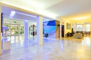 a large lobby with a large painting on the wall at Hotel Cala Murada in Cala Murada