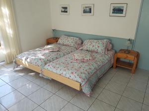 a bedroom with a bed and a night stand and a table at Casa Sandra in Locarno