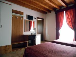 Postel nebo postele na pokoji v ubytování Hotel Agli Ulivi