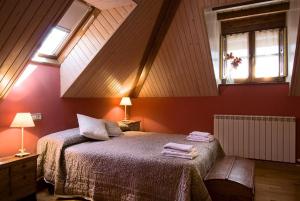 a bedroom with a bed with two towels on it at Casa Rural Marín in Hecho