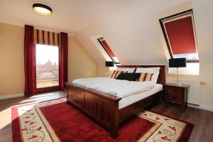 a bedroom with a bed and a large window at Good Luck Apartment in Hévíz