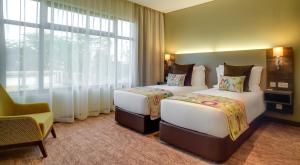 Katil atau katil-katil dalam bilik di Tamarind Tree Hotel