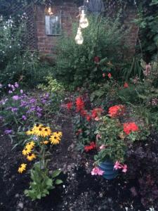 a garden with colorful flowers in front of a house at Chez Jo Apartments in Lewes