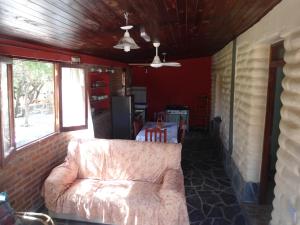 a living room with a couch and a brick wall at El Churqui in Humahuaca