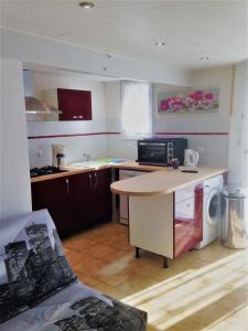 a kitchen with a desk and a microwave in it at les gites du gr224 in Pont-Audemer +30 photos