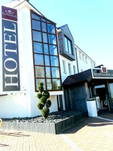 a building with a sign on the side of it at Hotel Constancja in Częstochowa