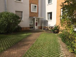a brick walkway leading to a building with a bike parked outside at Big and Beautiful in Hannover