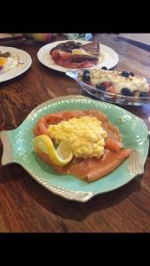 a plate of breakfast food on a wooden table at Drumbuie Farm B&B in Drumnadrochit