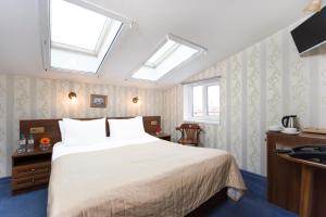 sypialnia z łóżkiem, 2 oknami i umywalką w obiekcie Hotel Moyka 5 w Petersburgu