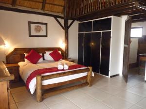 a bedroom with a bed with two slippers on it at Boskoppie Lion & Tiger Reserve in Kroonstad