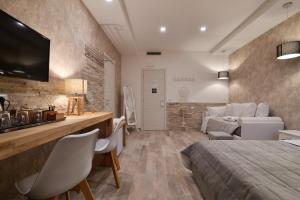 a bedroom with a bed and a living room at Veneto Suite Rome in Rome