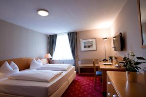 Postel nebo postele na pokoji v ubytování Hotel Das Kleine Ritz