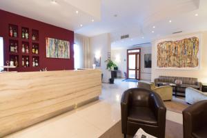 a lobby with a bar with chairs and a couch at Hotel Nuvò in Naples