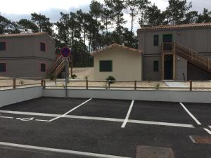 a parking lot with a ramp and a building at Villa Orchidee in Lacanau-Océan