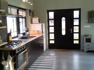 NagykőrösにあるBrendon Házのキッチン(黒いドア、冷蔵庫付)