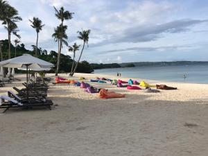 a group of people laying on a beach at Boracay Oceanway Residences - Island Paradise in Boracay +33 photos