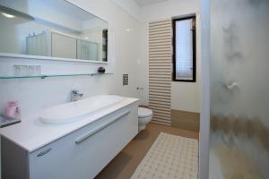 a white bathroom with a sink and a toilet at Apartments Andreja in Pag +162 photos