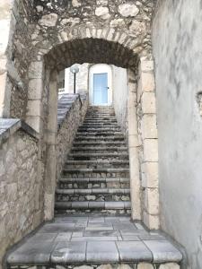 a stone stairway leading up to a blue door at Hotel Boutique Il Castellino Relais in Vieste