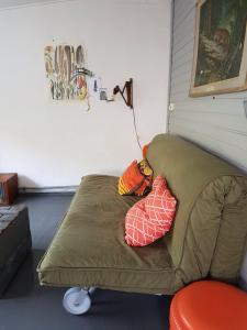 a couch with two pillows on it in a room at Hotel B&B Altijd Wad in West-Terschelling