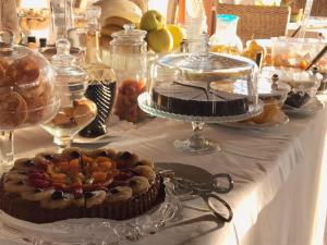 a table with a cake and other desserts on it at Hotel Boutique Il Castellino Relais in Vieste