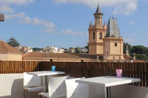 a group of tables on the roof of a building with a tower at L'Hostalet d'Arenys de Mar in Arenys de Mar