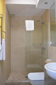a bathroom with a shower and a toilet and a sink at Casa Fayas in Ciutadella