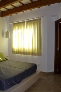 a bedroom with a bed and a window at Casa Fayas in Ciutadella