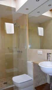 a bathroom with a shower and a toilet and a sink at Casa Fayas in Ciutadella
