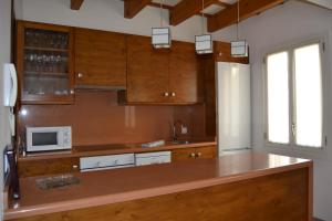 a kitchen with a counter top with a microwave at Casa Fayas in Ciutadella