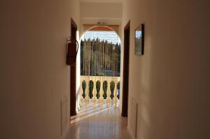 an empty hallway with chairs and an open window at Neptune Resort in Kavos