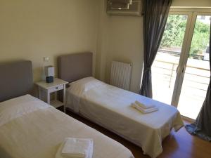 A bed or beds in a room at Legrena Beach Villa