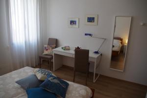 a bedroom with a desk and a bed and a mirror at Alla Torre B&B in Mestre