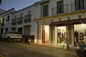 a person walking down a street in front of a store at Casa Rural Pueblos Blancos in Bornos