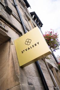 a sign for a shop on the side of a building at St Valery Boutique Bed + Breakfast in Alnmouth