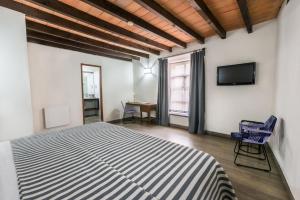 TV a/nebo společenská místnost v ubytování Hotel Abadia Tradicional
