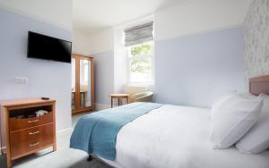 Ένα ή περισσότερα κρεβάτια σε δωμάτιο στο Gwesty Gadlys Hotel