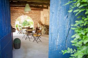 a room with a table and chairs and a blue wall at Le Clos Du Perret in Chaussan +41 photos
