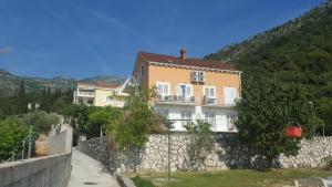 a building on top of a stone wall at Apartments Mimoza in Slano