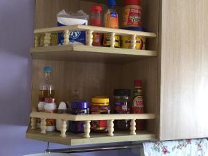 a cabinet filled with lots of spices and condiments at Pumzika Place in Nairobi