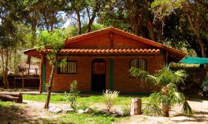 una pequeña casa de ladrillo en un patio con árboles en Monteverde en La Paz