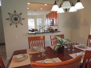 a kitchen and dining room with a table and chairs at Formosa Garden Pool Home in Orlando