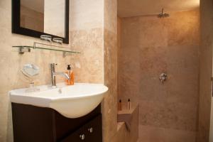 a bathroom with a sink and a shower at Keren's Vine Guesthouse in Stellenbosch +27 photos
