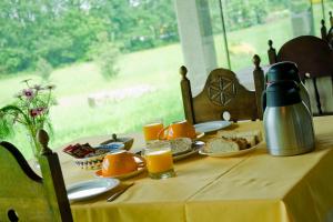 a table with food and orange juice on it at Pazo de Verdes in Cospeito