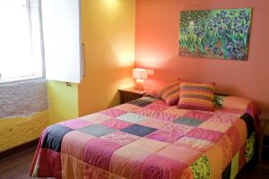 A bed or beds in a room at Pazo de Verdes
