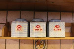 four cans of coffee sitting on a shelf at South Pacific Flat 2 in Marsaskala