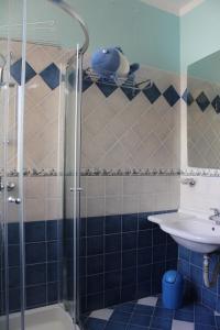 a bathroom with a shower and a sink at South Pacific Flat 2 in Marsaskala