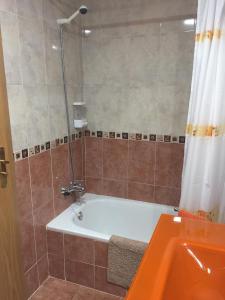 y baño con bañera y ducha con cortina de ducha. en Casa Vega, en Sobradiel