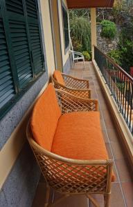 three wicker chairs sitting on a porch at Villa Catanho in Funchal